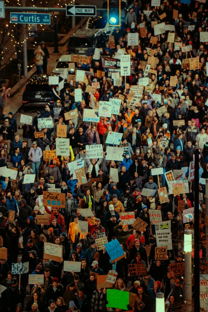 Crowd of demonstrators holding handmade signs at an immigration protest