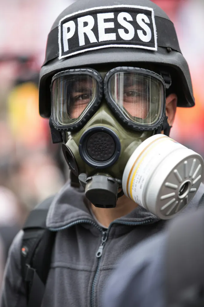 Crowd-control weapons: Person wearing a black and white protective gas mask