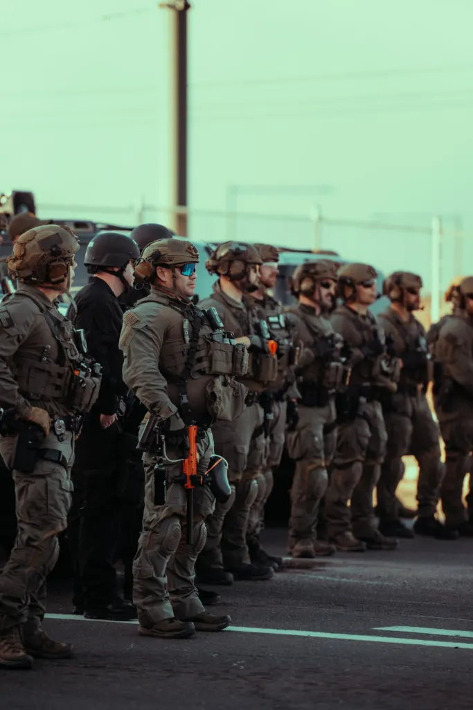 Row of armed officers standing on a street during a protest