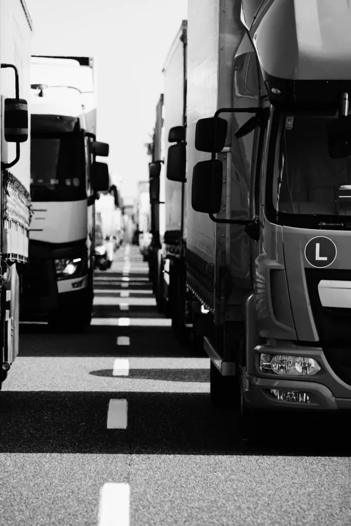 Line of semi trucks queued in traffic on a highway