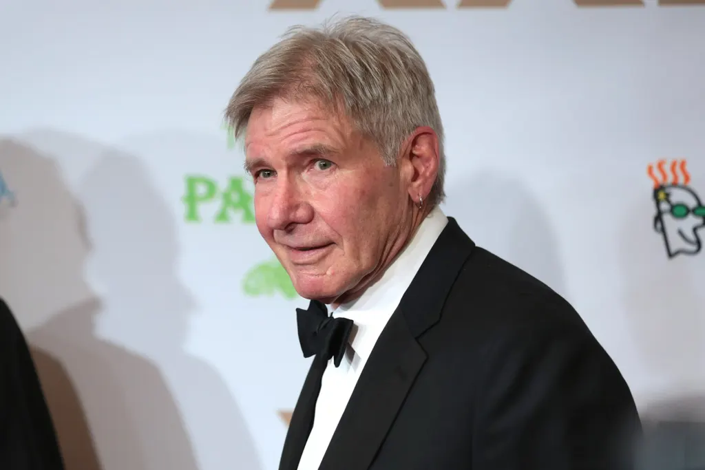 Harrison Ford smiling on a red carpet in Phoenix, Arizona