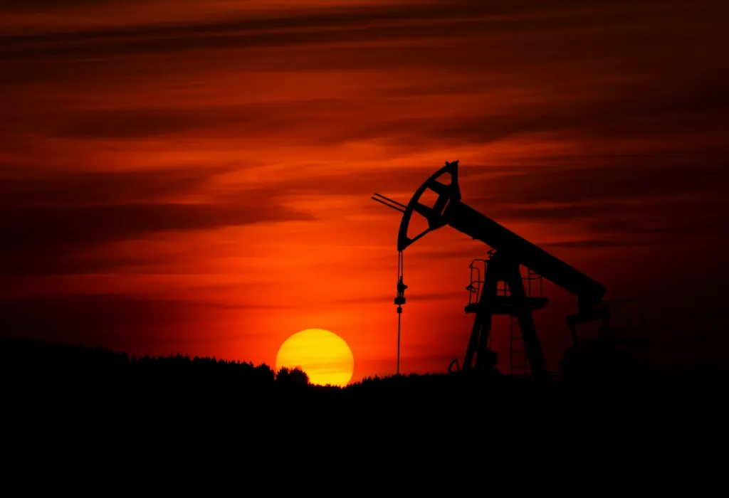 Harrison Ford Trump: Silhouette of an oil pump jack against a red sunset sky