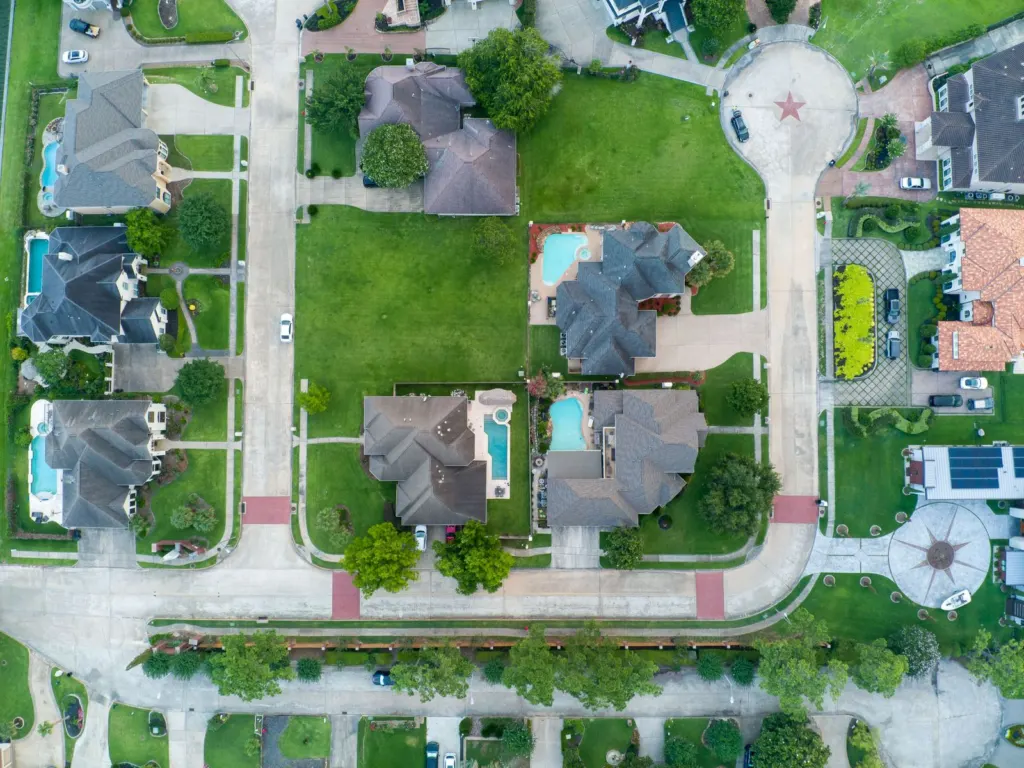 Aerial view of suburban houses with backyard pools in Texas