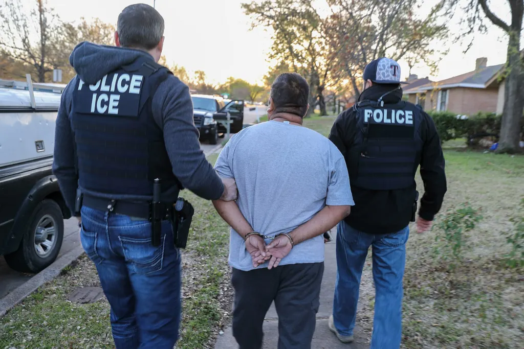 Immigration officers standing near a vehicle during a Texas operation