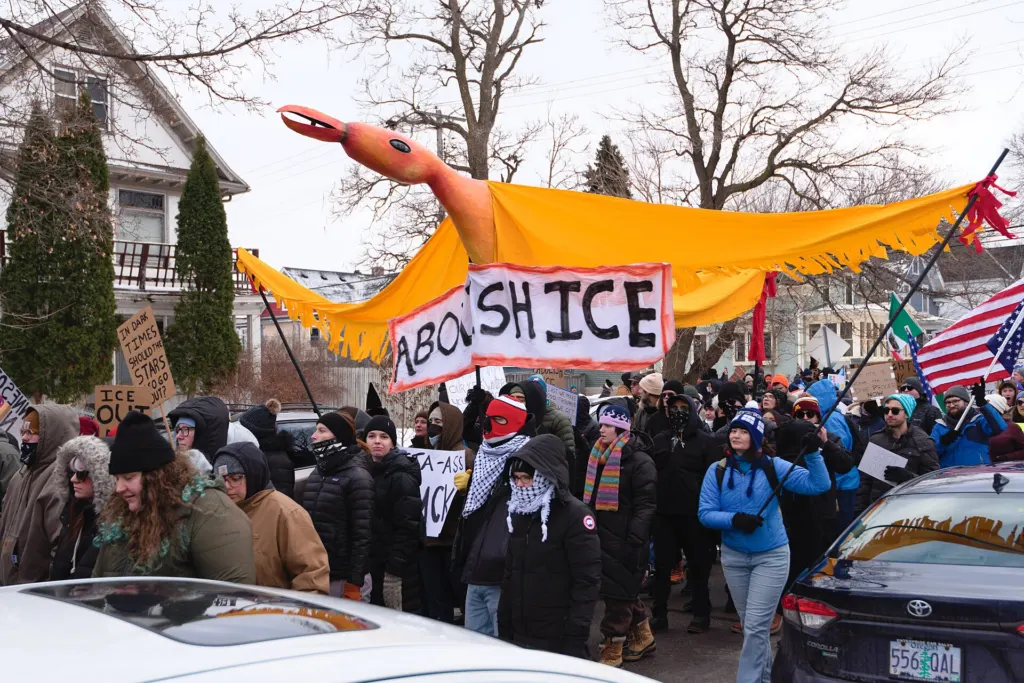 Marchers carrying signs along a street in Minneapolis