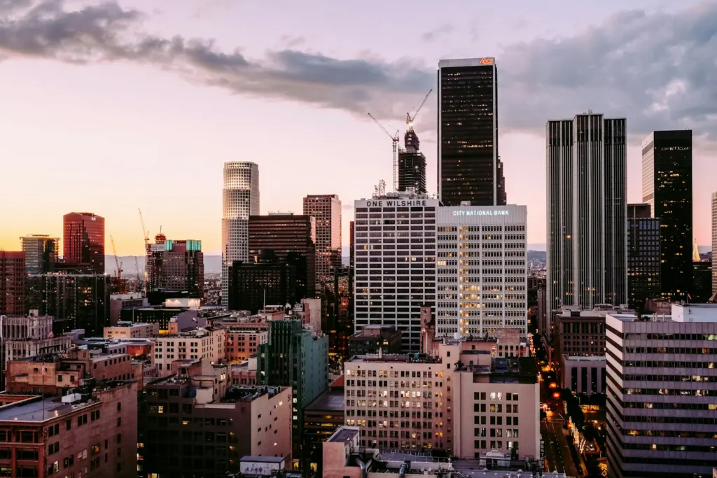Downtown Los Angeles towers glowing against the evening sky at dusk
