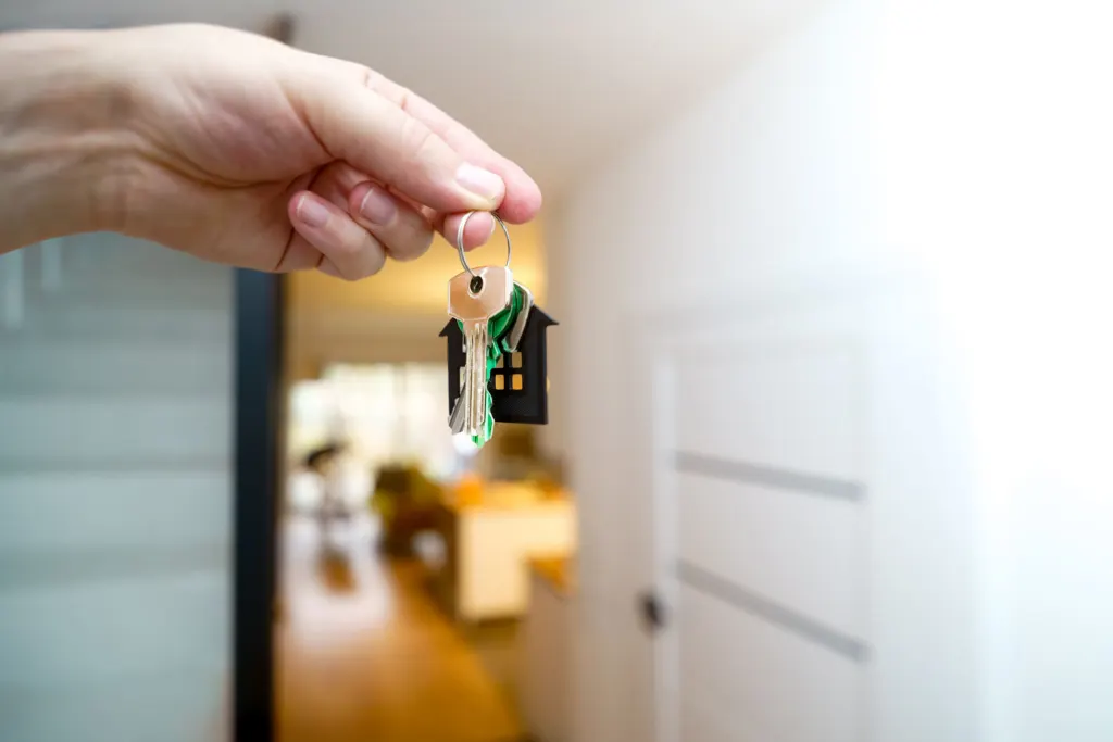 Miley Cyrus donation: A hand holding a ring of house keys inside a bright apartment