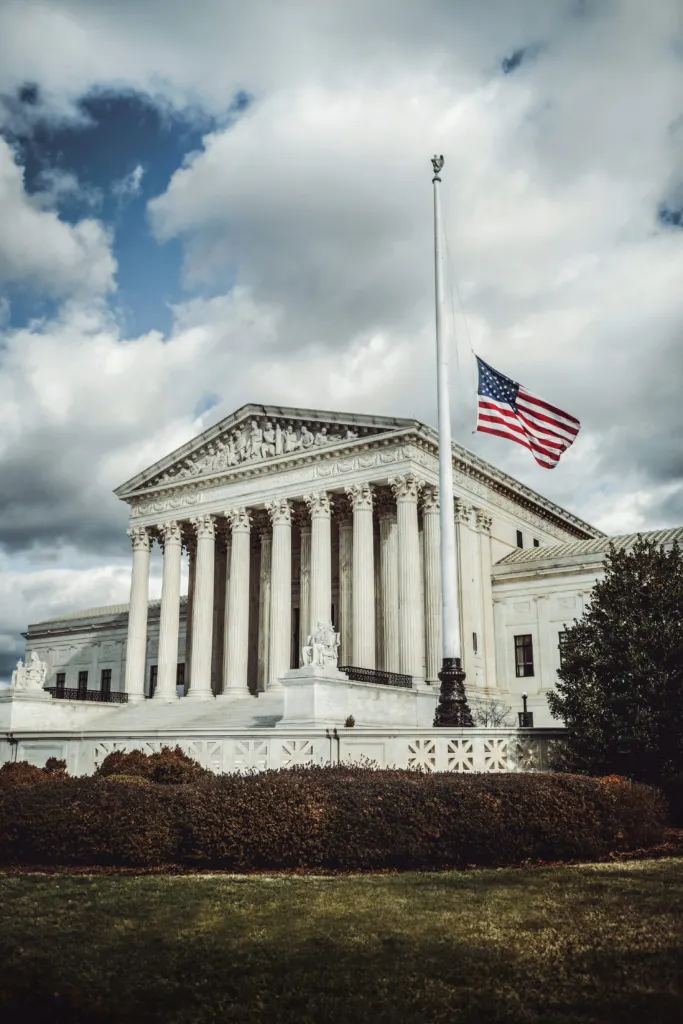 Supreme Court building facade with an American flag on top